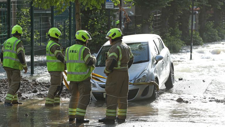 Firefighters on a flooded street in Finsbury Park, north London, after a pipe burst 