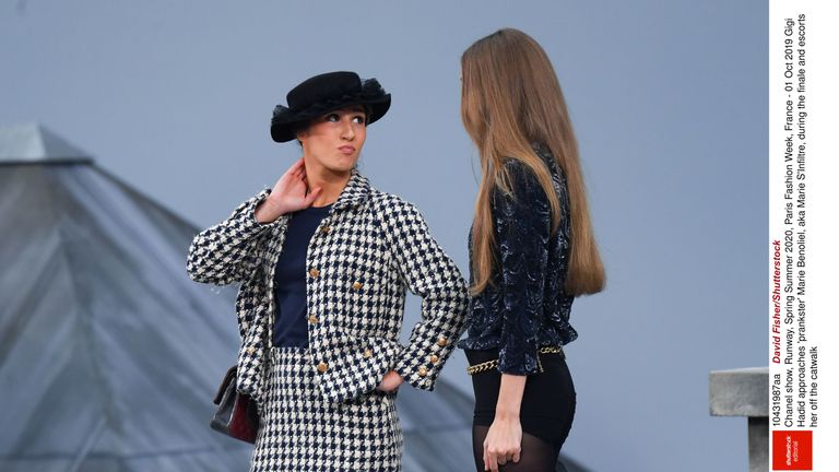 Gigi Hadid escorts an intruder from the Chanel Paris Fashion Week catwalk