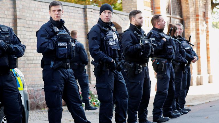 Police officers are lined up outside the synagogue in Halle