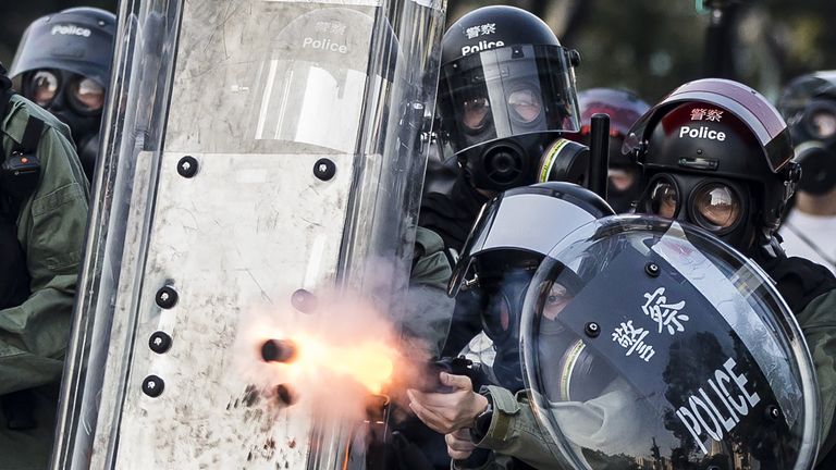 Riot police fire projectiles against protesters in the Sha Tin district of Hong Kong