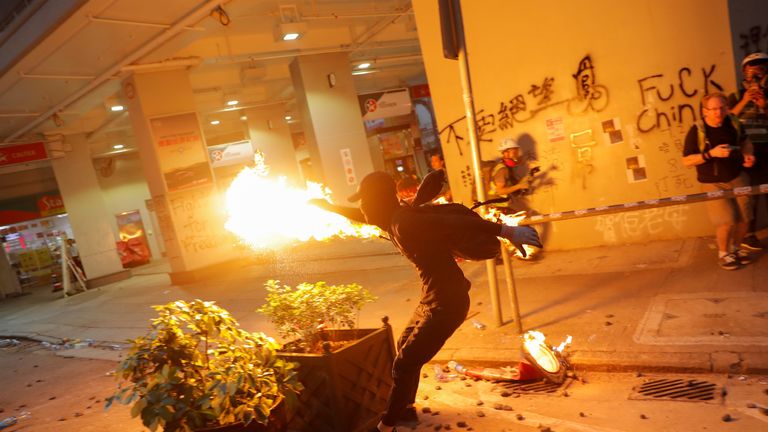 An anti-government protester throws a molotov cocktail 