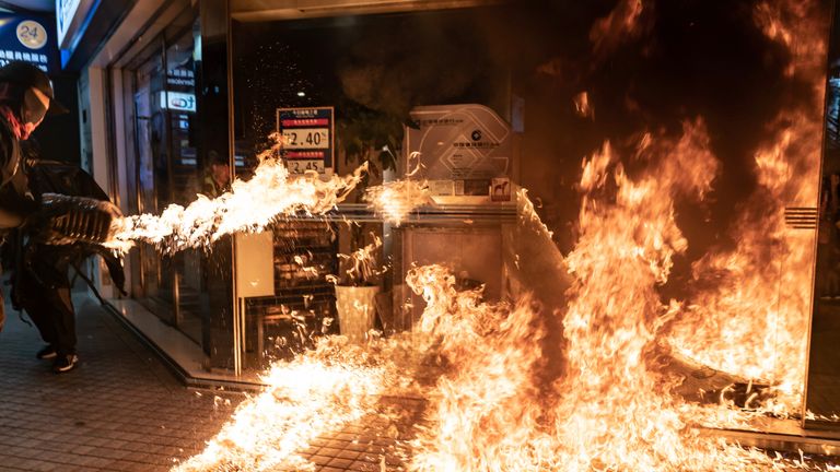 Pro-democracy protesters set a fire to a Chinese-owned bank