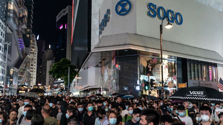 Pro-democracy protesters defied the ban on face masks as they marched in Causeway Bay