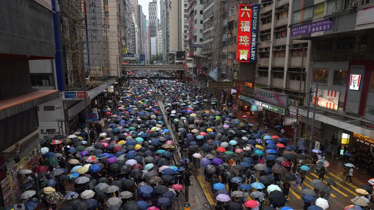 Thousands of people joined a protest march in the Causeway Bay shopping district on Sunday