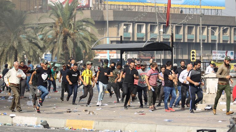 Protesters flee from riot police firing tear gas and live rounds during clashes 