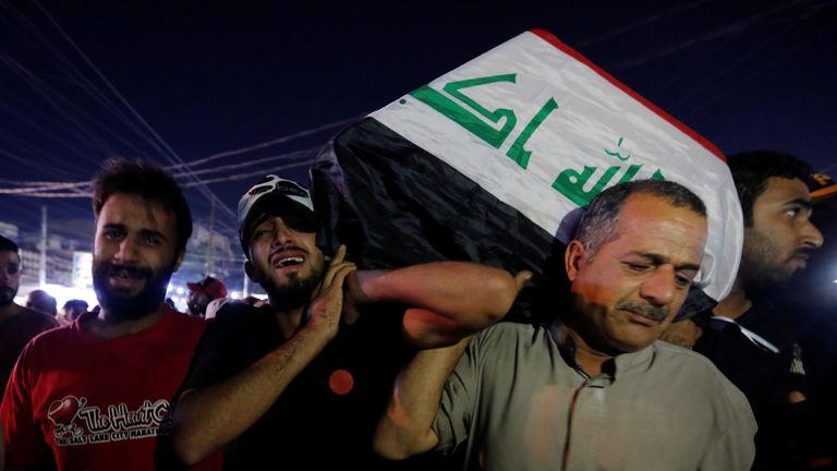 Men carry the coffin of a demonstrator who was killed during anti-government protests, in Baghdad