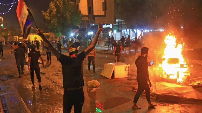 Iraqi protesters set fires to block roads in anti-government demonstration in the Shiite shrine city of Karbala