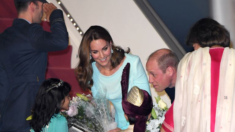 The Duke and Duchess speak to the two small children who gave them flowers after arriving in Nur Khan