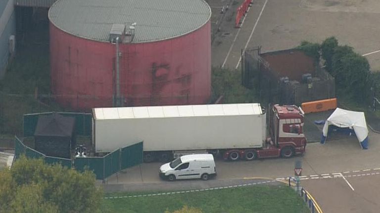 Lorry is surrounded by police and forensic team after discovery of 39 bodies inside it