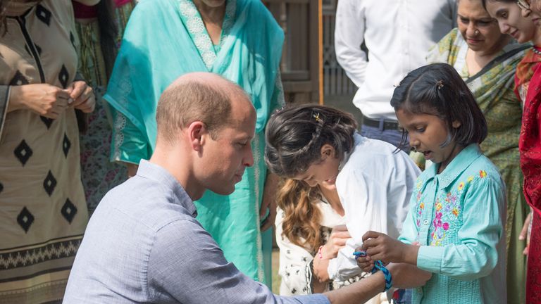 Prince William presented with handmade bracelet by little girl in Lahore, Pakistan