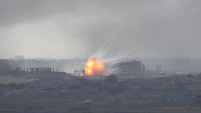 An explosion is seen over the Syrian town of Ras al-Ain as seen from the Turkish border town of Ceylanpinar