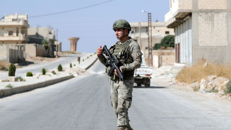 A Turkish solider patrols in the town of Tal Abyad, Syria
