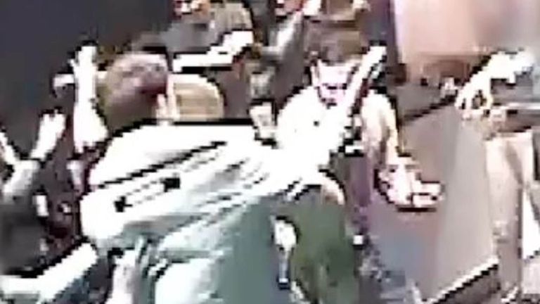 CCTV footage shows Josh Hanson (facing camera) with his hand up seconds after being stabbed