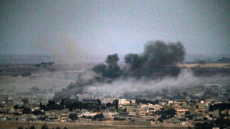 Smoke rises over the Syrian town of Ras al-Ain during Turkey's military offensive