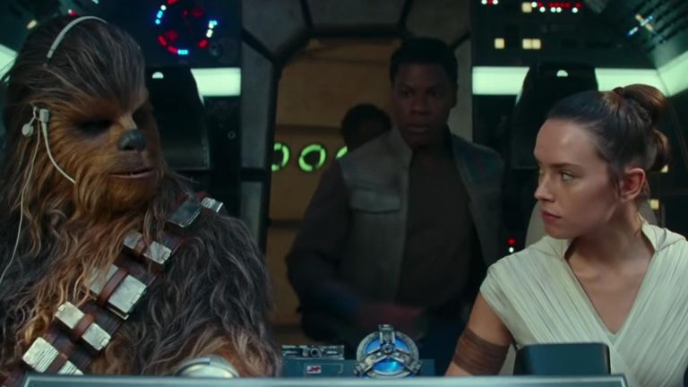 Rey in the cockpit of the Millennium Falcon with Chewbacca and Finn