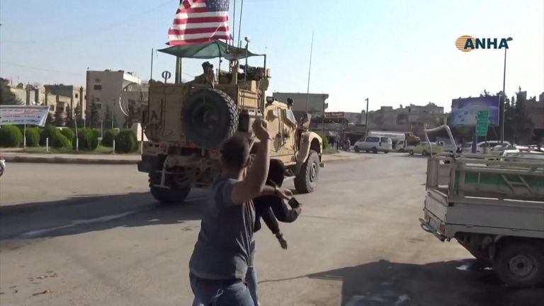 Syrians threw potatoes and yelled at U.S. armoured vehicles as U.S. troops drove through the northeast border town of Qamishli.