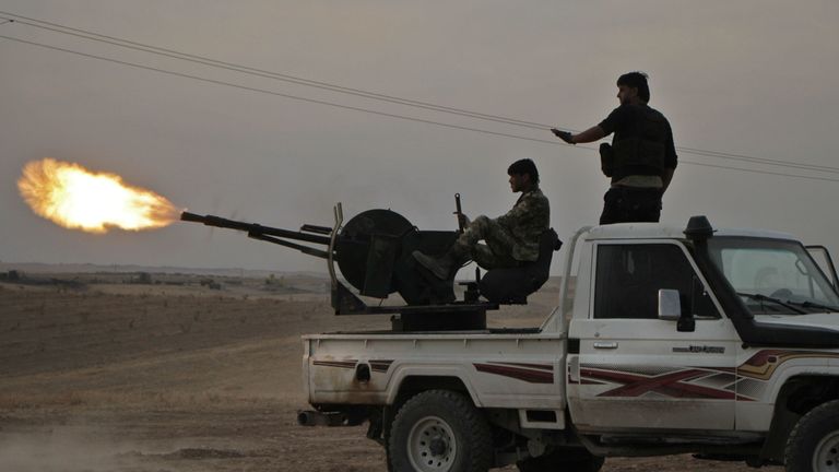 Turkish-backed Syrian fighters fire a truck mounted heavy gun near the town of Tukhar, north of Syria's northern city of Manbij, on October 14, 2019, as Turkey and it's allies continues their assault on Kurdish-held border towns in northeastern Syria. - Turkey wants to create a roughly 30-kilometre (20-mile) buffer zone along its border to keep Kurdish forces at bay and also to send back some of the 3.6 million Syrian refugees it hosts. (Photo by Aref TAMMAWI / AFP) (Photo by AREF TAMMAWI/AFP vi