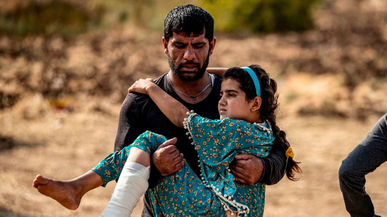 A Syrian girl injured by Turkish bombardment on Ras Al Ain is carried away from  hospital