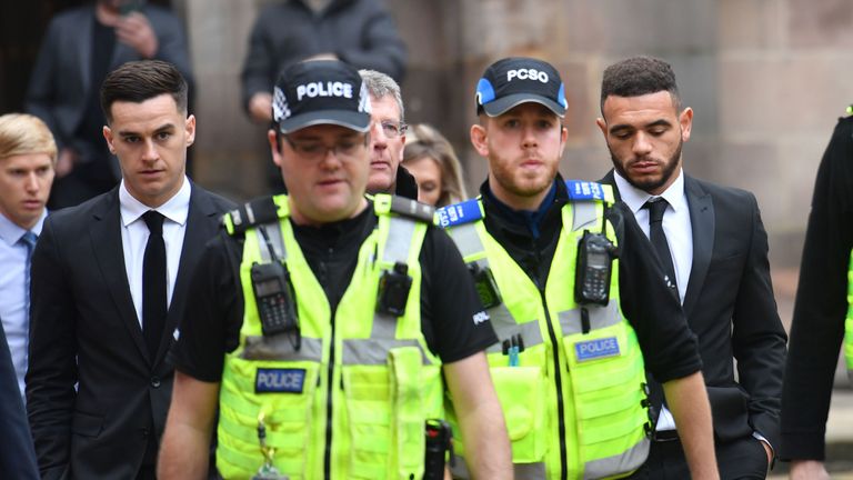 Police escort Tom Lawrence (far left) and Mason Bennett (far right) from Derby Magistrates' Court