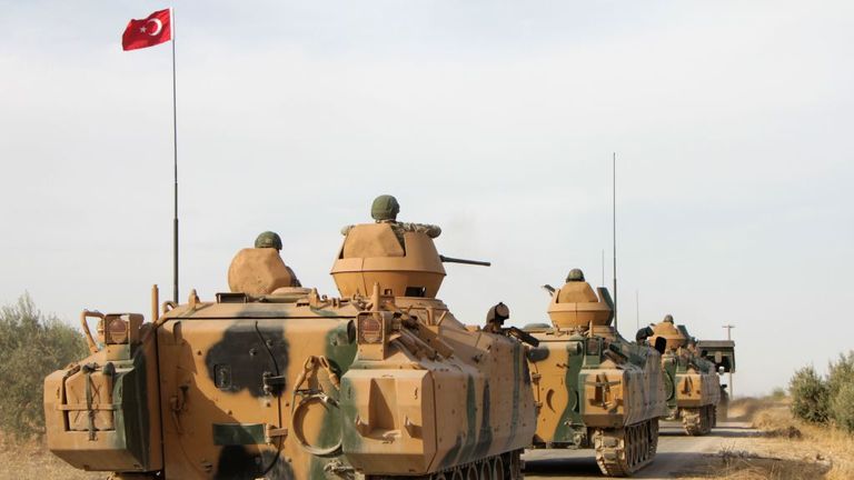 Turkish soldiers are trasported in armoured personnel carriers through the town of Tukhar, north of Syria&#39;s northern city of Manbij