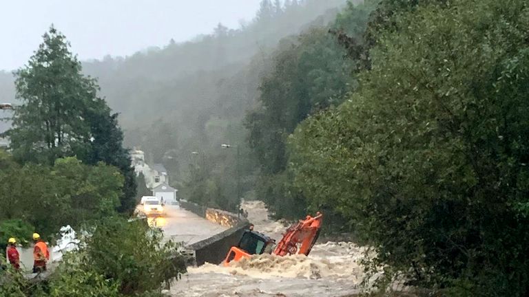 A construction vehicle appeared to have been knocked over by floodwater in Laxey