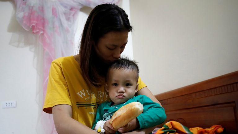 The wife and child of suspected victim Nguyen Dinh Tu