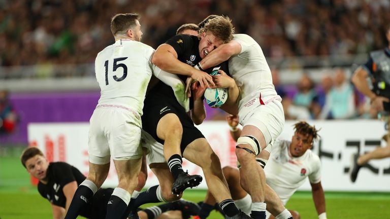 Jack Goodhue is tackled by the England defence