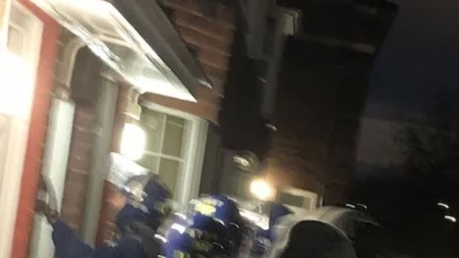 Officers entering a property during the raids. Pic: Met Police