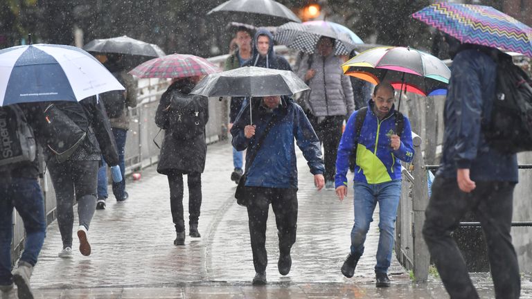 Pedestrian shelter from the rain under umbrellas in Bristol, after the Met Office warned of torrential rain and thunder in parts of the country.