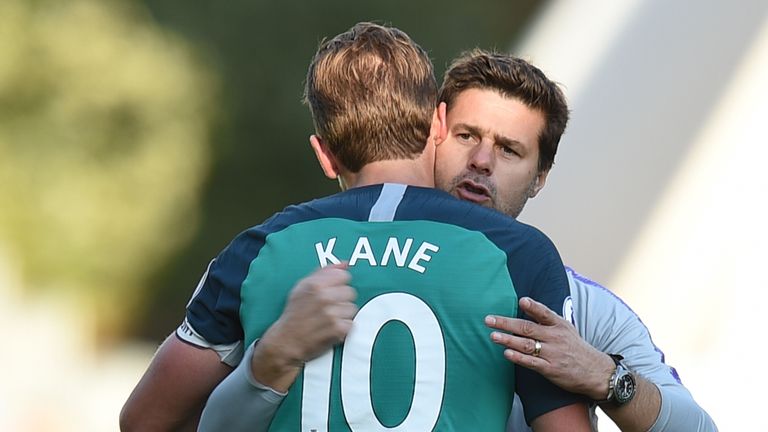 Tottenham Hotspur's Argentinian head coach Mauricio Pochettino (R) embraces Tottenham Hotspur's English striker Harry Kane (L) at the end of the English Premier League football match between Huddersfield Town and Tottenham Hotspur at the John Smith's stadium in Huddersfield, northern England on September 29, 2018. (Photo by Oli SCARFF / AFP) / RESTRICTED TO EDITORIAL USE. No use with unauthorized audio, video, data, fixture lists, club/league logos or 'live' services. Online in-match use limited to 120 images. An additional 40 images may be used in extra time. No video emulation. Social media in-match use limited to 120 images. An additional 40 images may be used in extra time. No use in betting publications, games or single club/league/player publications. /         (Photo credit should read OLI SCARFF/AFP via Getty Images)