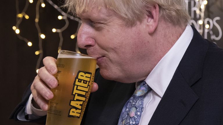 Britain's Prime Minister Boris Johnson takes a sip from a pint of Rattler cider as he visits Healey's Cornish Cyder Farm in Callestick, Cornwall on November 27, 2019, during Conservative Party campaigning for the upcoming general elections. - Britain will go to the polls on December 12, 2019 to vote in a pre-Christmas general election. (Photo by Dan Kitwood / POOL / AFP) (Photo by DAN KITWOOD/POOL/AFP via Getty Images)