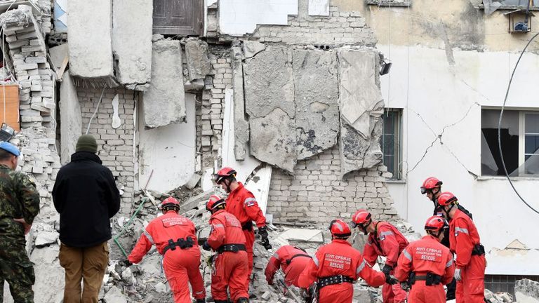 Serbian rescuers dig through rubble in Thumane, where five bodies were pulled out on Wednesday