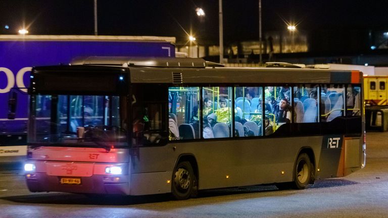 A bus with refugees drives away from the DFDS ferry, in the harbour of Vlaardingen, The Netherlands