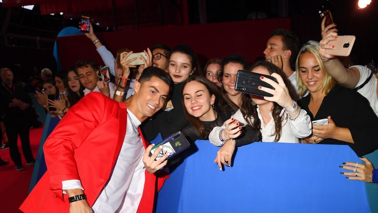 Footballer Cristiano Ronaldo met fans on the red carpet before taking his seat in the audience