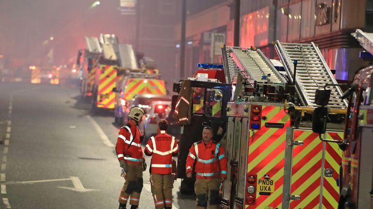 Firefighters at the scene after a fire on the top floors of a building on Bradshawgate in Bolton