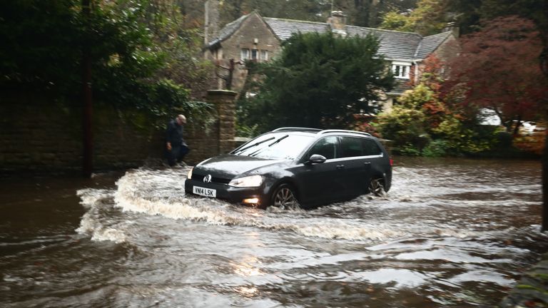 A car passing through a flooded road in Whirlow, Sheffield