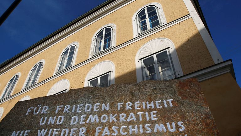 A stone outside the house with the inscription 'For peace, freedom and democracy, never again fascism, millions of dead are a warning'