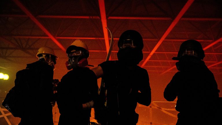 Anti-government protesters are silhouetted at the Hong Kong Polytechnic University (PolyU) during a fire in Hong Kong, China, November 18, 2019