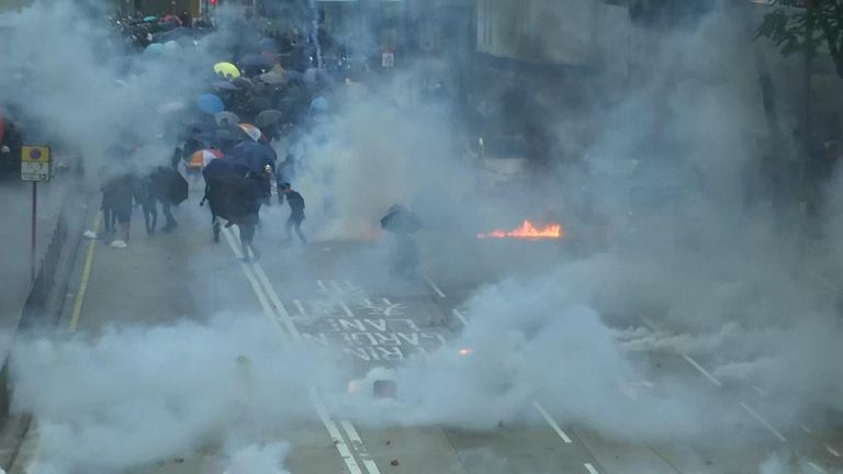 Defying a police ban, thousands of protesters were streaming into Hong Kong's central shopping district on Saturday for another rally 