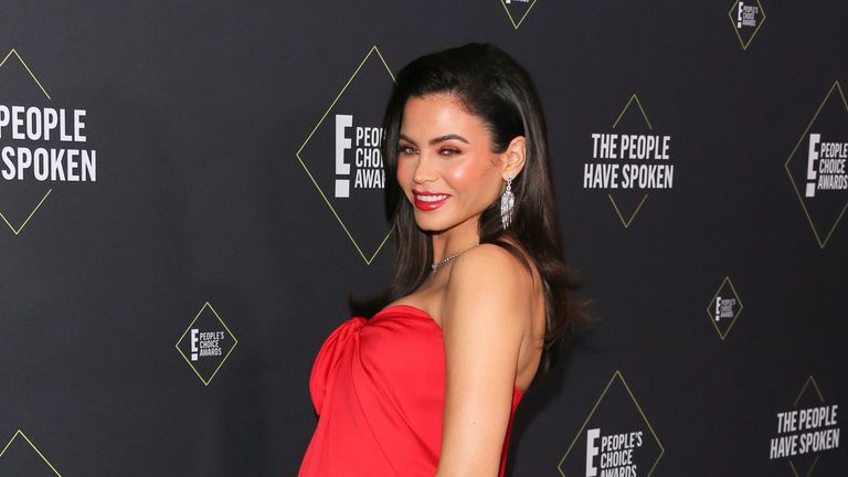 Jenna Dewan cradled her baby bump in a red Monique Lhuillier gown