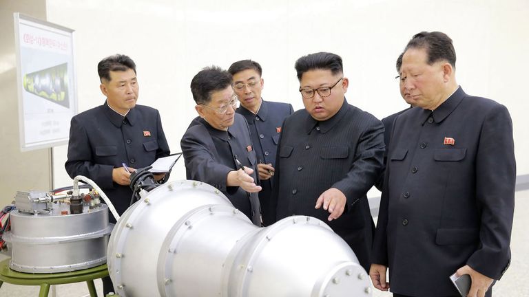 TOPSHOT - This undated picture released by North Korea&#39;s official Korean Central News Agency (KCNA) on September 3, 2017 shows North Korean leader Kim Jong-Un (C) looking at a metal casing with two bulges at an undisclosed location. North Korea has developed a hydrogen bomb which can be loaded into the country&#39;s new intercontinental ballistic missile, the official Korean Central News Agency claimed on September 3. Questions remain over whether nuclear-armed Pyongyang has successfully miniaturise