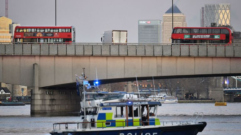 A police boat patrols along the River Thames after the suspect was shot dead