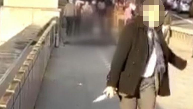 A man removes a knife from the scene of the London Bridge attack