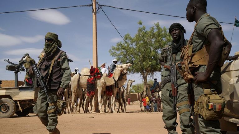 Malian soldiers patrol the streets of Menaka, Mali