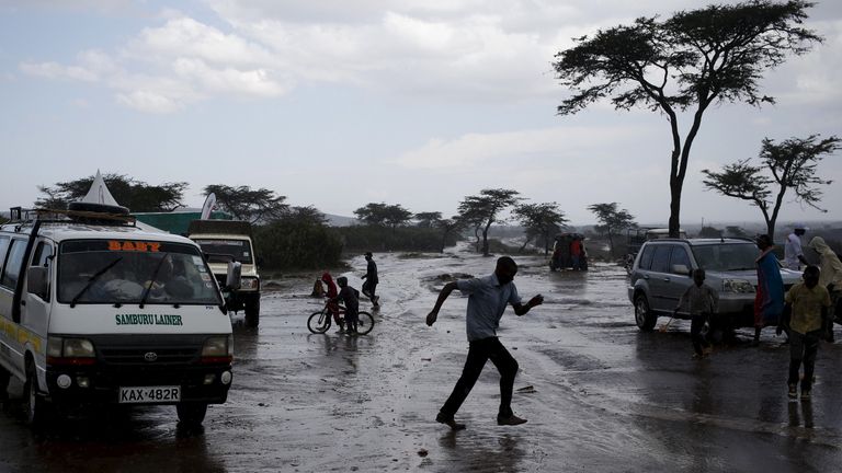 A man runs during heavy rain during the Maralal Camel Derby, Kenya, August 15, 2015. Maralal, a small, arid town about an eight-hour drive north of the Kenyan capital Nairobi