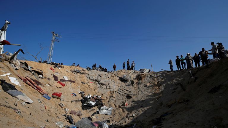 Palestinians gather at the scene of an Israeli air strike in the central Gaza Strip