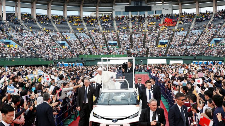 Pope Francis greets wellwishers from his Popemobile during a Holy Mass in Nagasaki