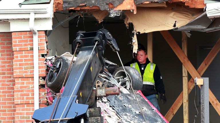 A Porsche is removed form the second story of a building after the convertible went airborne 