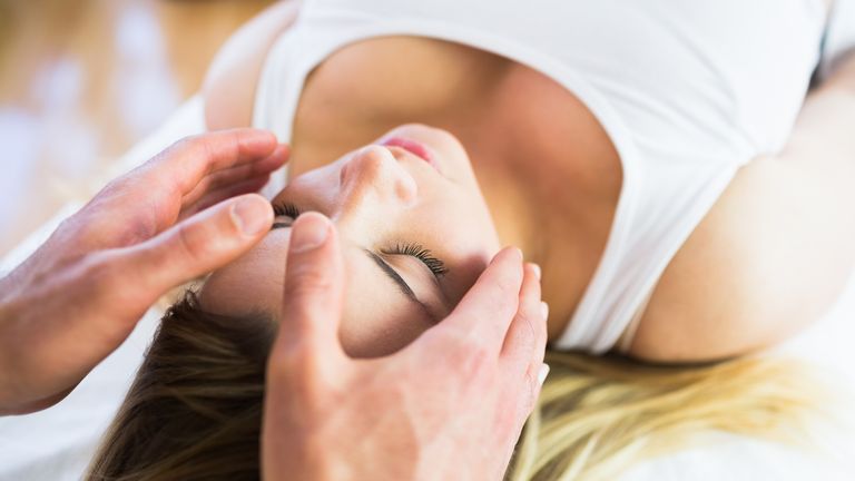 Reiki, a form of alternative medicine, uses a palm healing technique on patients