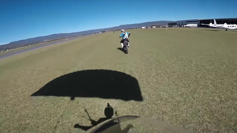 Scott Hiscoe jump from a plane to land on a motorcycle.